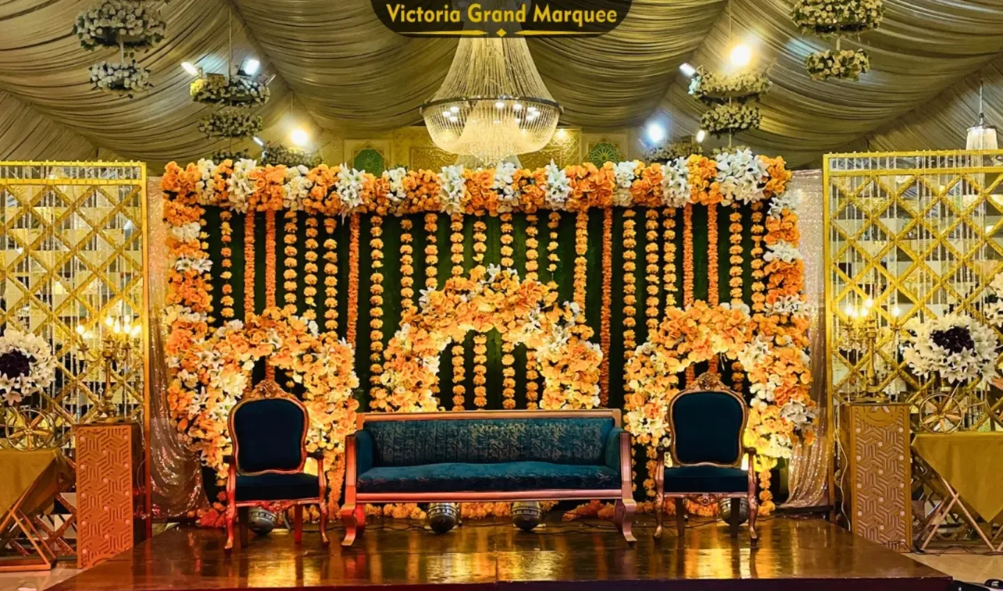 Mehndi stage layered with marigold garlands and colourful seating