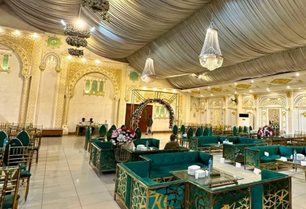 Teal velvet guest seating arranged across the air-conditioned hall