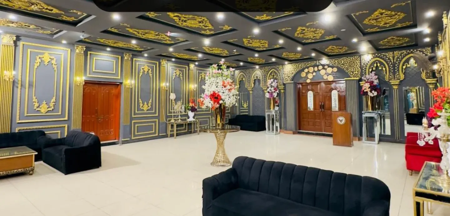 Reception hall with gold-leaf ceiling panels and velvet lounge seating